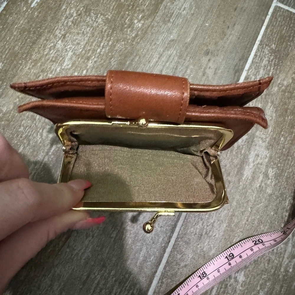 Vintage Brown Leather Wallet with Snap Closure and Embossed Emblem
